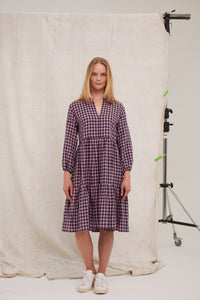 Pink/Navy gingham Irish linen midi dress. Easy fit. Tiered dress. Notch neck topped with tiny ruffle Pockets. Hook and eye at neck. Unlined. Midi length. Long sleeves. Easy fit. 100% Irish linen